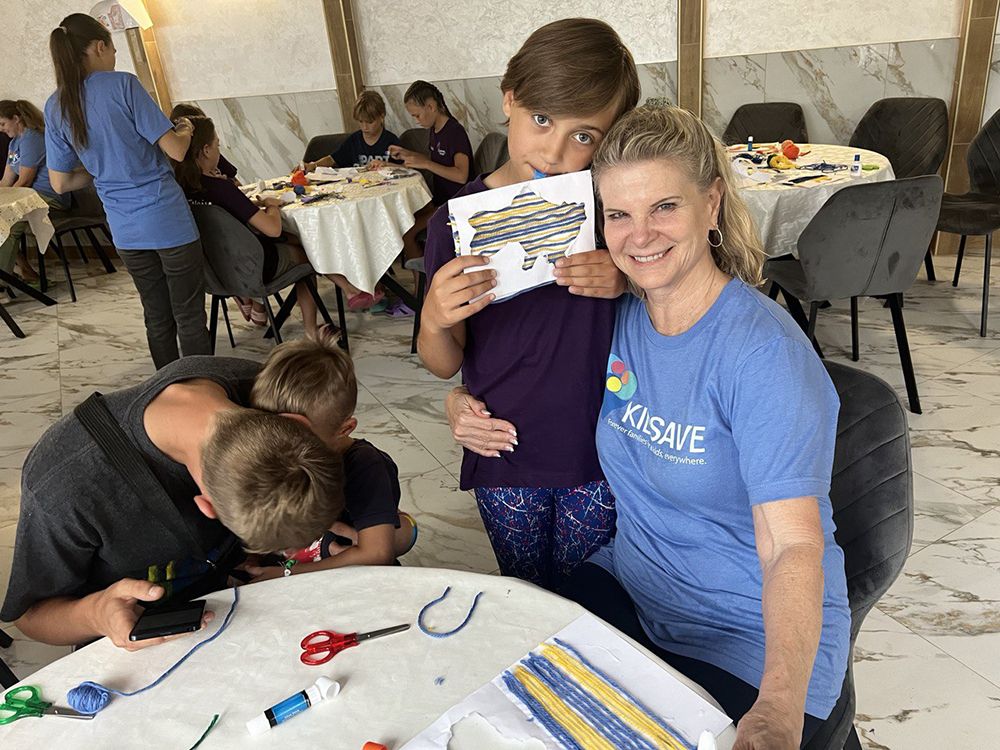 KIDSAVE-MIRACLES-CENTER-RANDI-POSING-WITH-KID-AND-THEIR-DRAWING